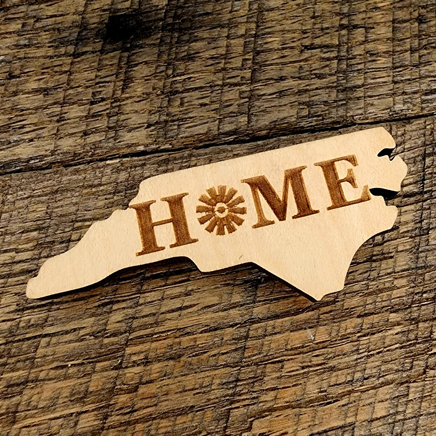North Carolina Shaped Magnet with Home on product. O in Home is a windmill
