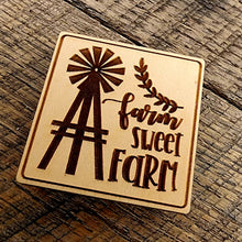 Load image into Gallery viewer, Magnet with &quot;Farm Sweet Farm&quot; printed on it. A windmill design to the left of the lettering and the magnet is tilted right
